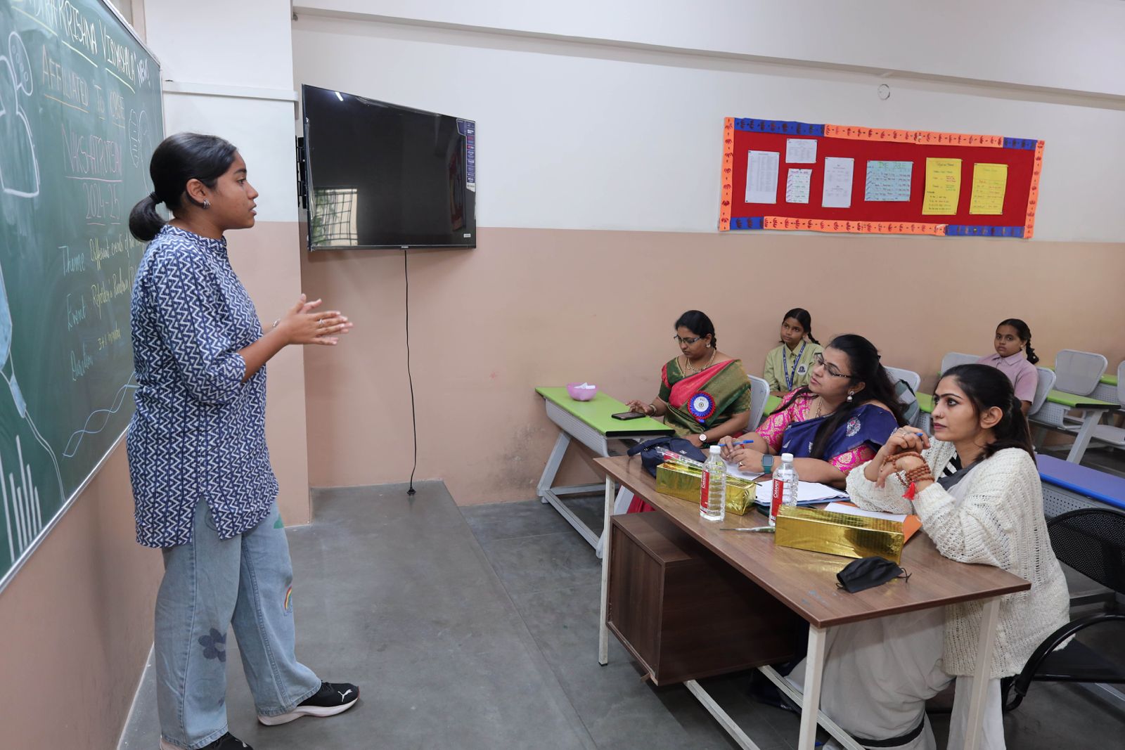 Teacher guiding students in project-based learning in CBSE primary class