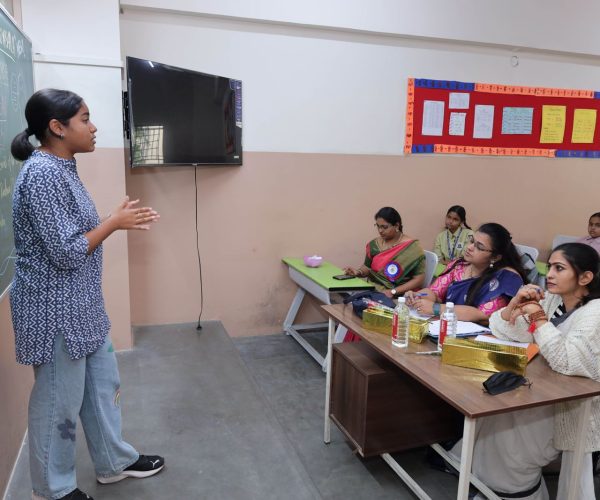 Teacher guiding students in project-based learning in CBSE primary class
